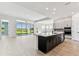 Modern kitchen with a large island, stainless steel appliances, and open floor plan at 5979 Hidden Branch Dr, Apollo Beach, FL 33572