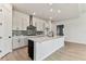 Contemporary kitchen with a central island, pendant lighting, and stainless steel appliances at 5979 Hidden Branch Dr, Apollo Beach, FL 33572