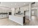 Well-lit kitchen with a central island, modern appliances, and sleek cabinetry at 5979 Hidden Branch Dr, Apollo Beach, FL 33572