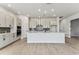 Modern kitchen features white cabinets, stainless steel appliances, and a stylish backsplash, creating a chef's dream at 5979 Hidden Branch Dr, Apollo Beach, FL 33572