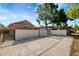 Spacious backyard with concrete driveway, white fence, and secure gated entry at 6414 N Central Ave, Tampa, FL 33604