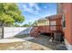 Exterior view of a backyard with a deck and white fence at 6414 N Central Ave, Tampa, FL 33604