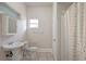 Bathroom featuring white fixtures and a shower with a patterned curtain at 6414 N Central Ave, Tampa, FL 33604