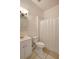 Bathroom featuring white fixtures, a shower with a patterned curtain, and tiled flooring at 6414 N Central Ave, Tampa, FL 33604