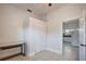 Open bedroom with white walls, tile flooring and a closet; kitchen visible through doorway at 6414 N Central Ave, Tampa, FL 33604