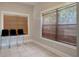 Sunlit room with tiled floor, three chairs, and a pair of windows at 6414 N Central Ave, Tampa, FL 33604