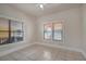 Bedroom featuring a ceiling fan, tiled floors, and large windows at 6414 N Central Ave, Tampa, FL 33604