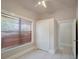 Bedroom featuring a closet and windows with wood-look blinds at 6414 N Central Ave, Tampa, FL 33604