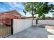 Large driveway features a peach home, black gates, and white privacy fence at 6414 N Central Ave, Tampa, FL 33604
