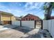 Wide driveway leading to the home, bordered by a white privacy fence and black iron gates at 6414 N Central Ave, Tampa, FL 33604