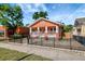 Charming home with a porch, black iron fence, and well-maintained front yard at 6414 N Central Ave, Tampa, FL 33604