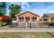 Charming home with a porch, black iron fence, and well-maintained front yard at 6414 N Central Ave, Tampa, FL 33604