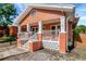 A charming home with a delightful front porch, showcasing its unique design and architectural features at 6414 N Central Ave, Tampa, FL 33604