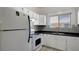 Bright kitchen features white appliances, ample cabinet space, and a window at 6414 N Central Ave, Tampa, FL 33604