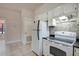 Well-lit kitchen featuring white appliances and cabinetry for a clean, functional design at 6414 N Central Ave, Tampa, FL 33604