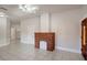 Bright living room with a decorative brick fireplace and tiled floors at 6414 N Central Ave, Tampa, FL 33604