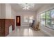Open living room with tile floors, a decorative fireplace, and lots of natural light at 6414 N Central Ave, Tampa, FL 33604