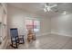 Bright living room with two rocking chairs, tile floors, and a large window at 6414 N Central Ave, Tampa, FL 33604
