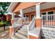 Spacious porch with classic columns, and staircase at 6414 N Central Ave, Tampa, FL 33604