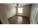 Bedroom with hardwood floors, a window with natural light, neutral walls, and a ceiling fan at 6618 Pineview Ter # 6618, Bradenton, FL 34203