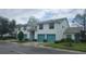 Townhome with well-manicured landscaping, colorful garages, and a serene residential street at 6618 Pineview Ter # 6618, Bradenton, FL 34203