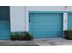 Attached garage with a light blue door and a partial view of the unit's entrance at 6618 Pineview Ter # 6618, Bradenton, FL 34203