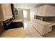 Spacious kitchen featuring stainless steel appliances, white cabinetry, tile flooring, and a built-in desk at 6618 Pineview Ter # 6618, Bradenton, FL 34203
