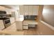 Modern kitchen with white cabinets, stainless steel appliances, tile floors, and a built-in desk area at 6618 Pineview Ter # 6618, Bradenton, FL 34203