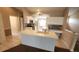 Bright kitchen featuring white cabinetry, an island sink, modern appliances, and updated countertops and backsplash at 6618 Pineview Ter # 6618, Bradenton, FL 34203