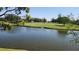 A serene pond view overlooks a verdant green golf course surrounded by lush trees at 6618 Pineview Ter # 6618, Bradenton, FL 34203