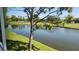 A serene pond view overlooks a verdant green golf course surrounded by lush trees at 6618 Pineview Ter # 6618, Bradenton, FL 34203