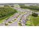 Aerial view showcasing houses, community ponds, lush trees, and community streets at 10815 Windswept Garden Way, Tampa, FL 33647