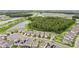 An aerial view of homes, community ponds and lush trees, and roadways in the area at 10815 Windswept Garden Way, Tampa, FL 33647