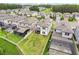Aerial view of a backyard with a screened enclosure and well-maintained green lawn, surrounded by a white picket fence at 10815 Windswept Garden Way, Tampa, FL 33647