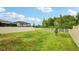 Spacious backyard with green grass and a white vinyl privacy fence and a black-topped gazebo at 10815 Windswept Garden Way, Tampa, FL 33647