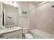Well-lit bathroom with granite countertop, tiled shower, and modern fixtures at 10815 Windswept Garden Way, Tampa, FL 33647