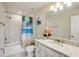 Bathroom featuring tub, marble countertop vanity with modern fixtures and beach themed shower curtain at 10815 Windswept Garden Way, Tampa, FL 33647