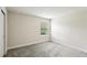 Bright bedroom featuring plush carpet, neutral walls and a window providing natural light at 10815 Windswept Garden Way, Tampa, FL 33647