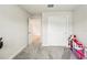 Bedroom featuring neutral walls and carpet, closet and open doorway to another room at 10815 Windswept Garden Way, Tampa, FL 33647