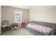 Cozy bedroom featuring daybed, play kitchen, and window with outdoor view at 10815 Windswept Garden Way, Tampa, FL 33647