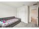 Neutral bedroom with plush carpeting, daybed, closet, and open doorway at 10815 Windswept Garden Way, Tampa, FL 33647