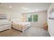 Bedroom featuring neutral walls and carpet, a large bed, a dresser and two windows at 10815 Windswept Garden Way, Tampa, FL 33647