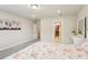 Bright bedroom features carpet flooring, walk-in closet, and a decorative strawberry themed comforter set at 10815 Windswept Garden Way, Tampa, FL 33647