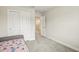 Neutral bedroom with plush carpeting, daybed, closet, and hallway doorway at 10815 Windswept Garden Way, Tampa, FL 33647