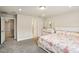 Bedroom featuring neutral walls and carpet, a large bed, a dresser and ensuite bathroom at 10815 Windswept Garden Way, Tampa, FL 33647