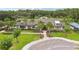 A well-manicured clubhouse with tropical landscaping, a circular drive and ample parking at 10815 Windswept Garden Way, Tampa, FL 33647