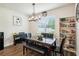 Cozy dining space with a piano, decorative lighting, and a bookcase for books and decorations at 10815 Windswept Garden Way, Tampa, FL 33647