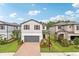 Charming two-story home with a brick driveway, well-manicured landscaping and attached two-car garage at 10815 Windswept Garden Way, Tampa, FL 33647