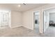 Neutral hallway with wall decor leading to playroom and bedroom at 10815 Windswept Garden Way, Tampa, FL 33647