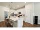 Well-lit kitchen with stainless appliances, a center island with seating, and a view to the backyard at 10815 Windswept Garden Way, Tampa, FL 33647
